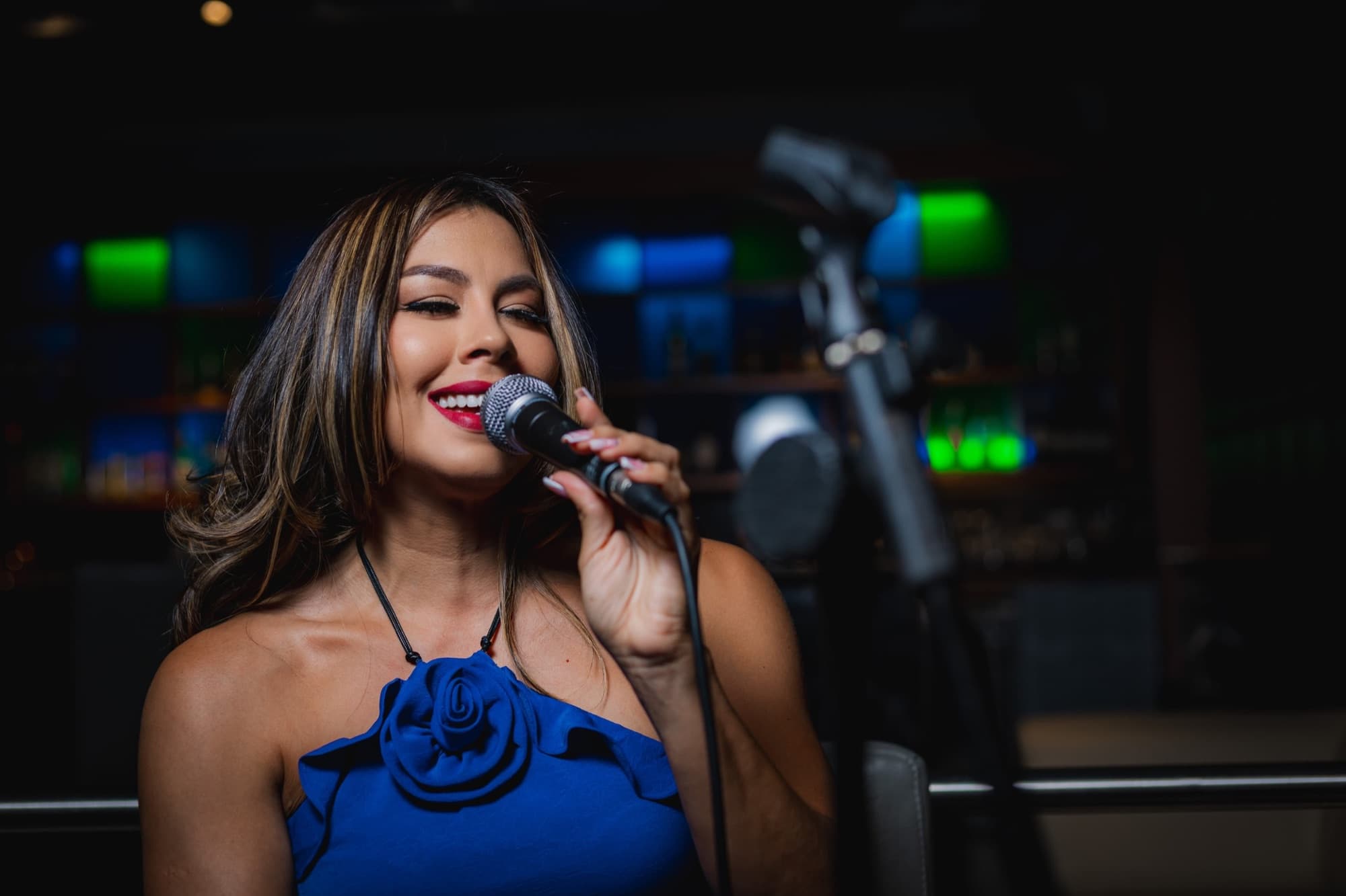 Astra vocalist performing at a bar in Aruba